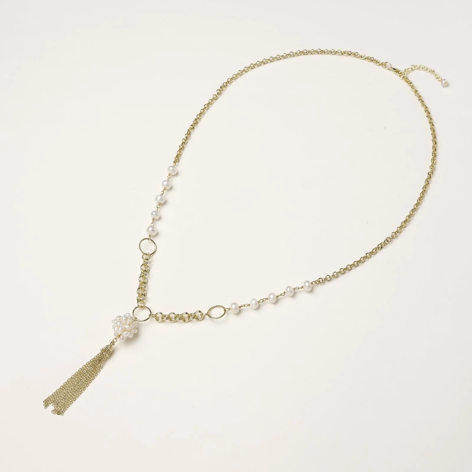 Long gold-plated necklace with freshwater pearls, chunky chain links, and flowing tassel pendant