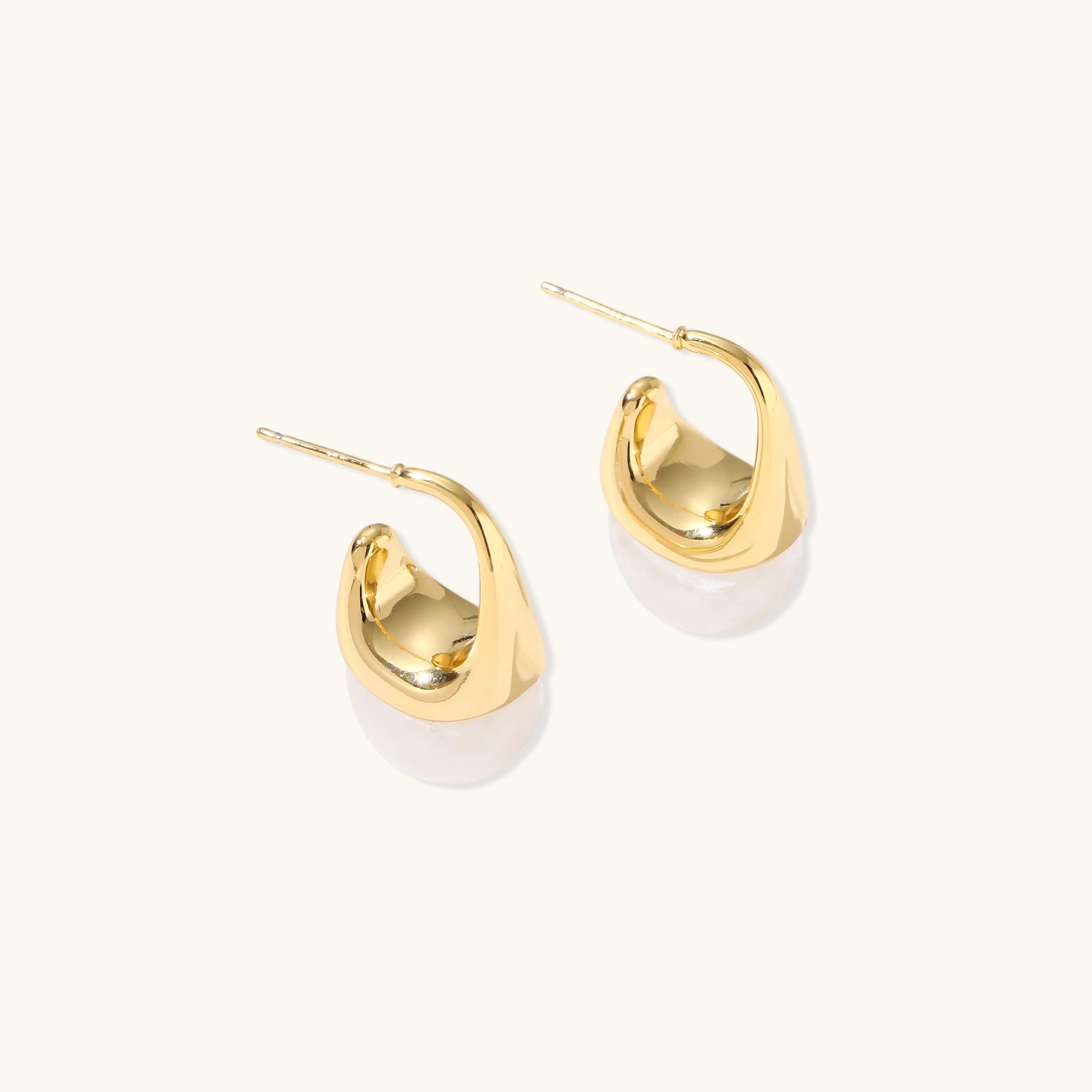 Pair of small gold-plated hoop earrings with triangular cone fronts and curved backs on white background.